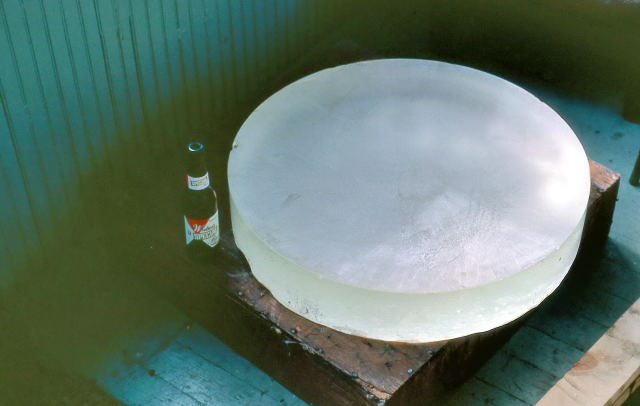 26-in mirror blank sitting on its crate